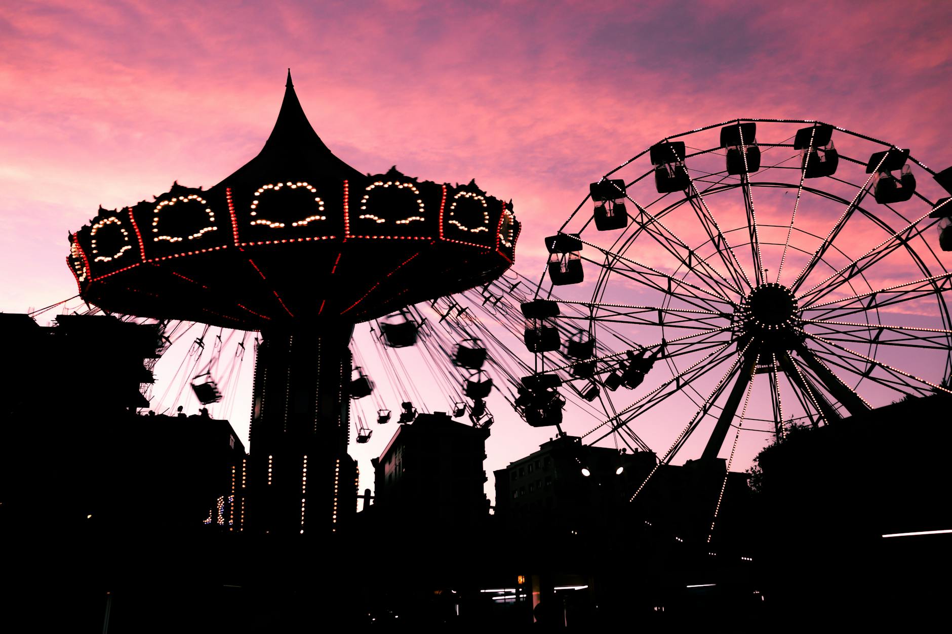 An Orlando theme park lit up in the evening during extended nighttime hours