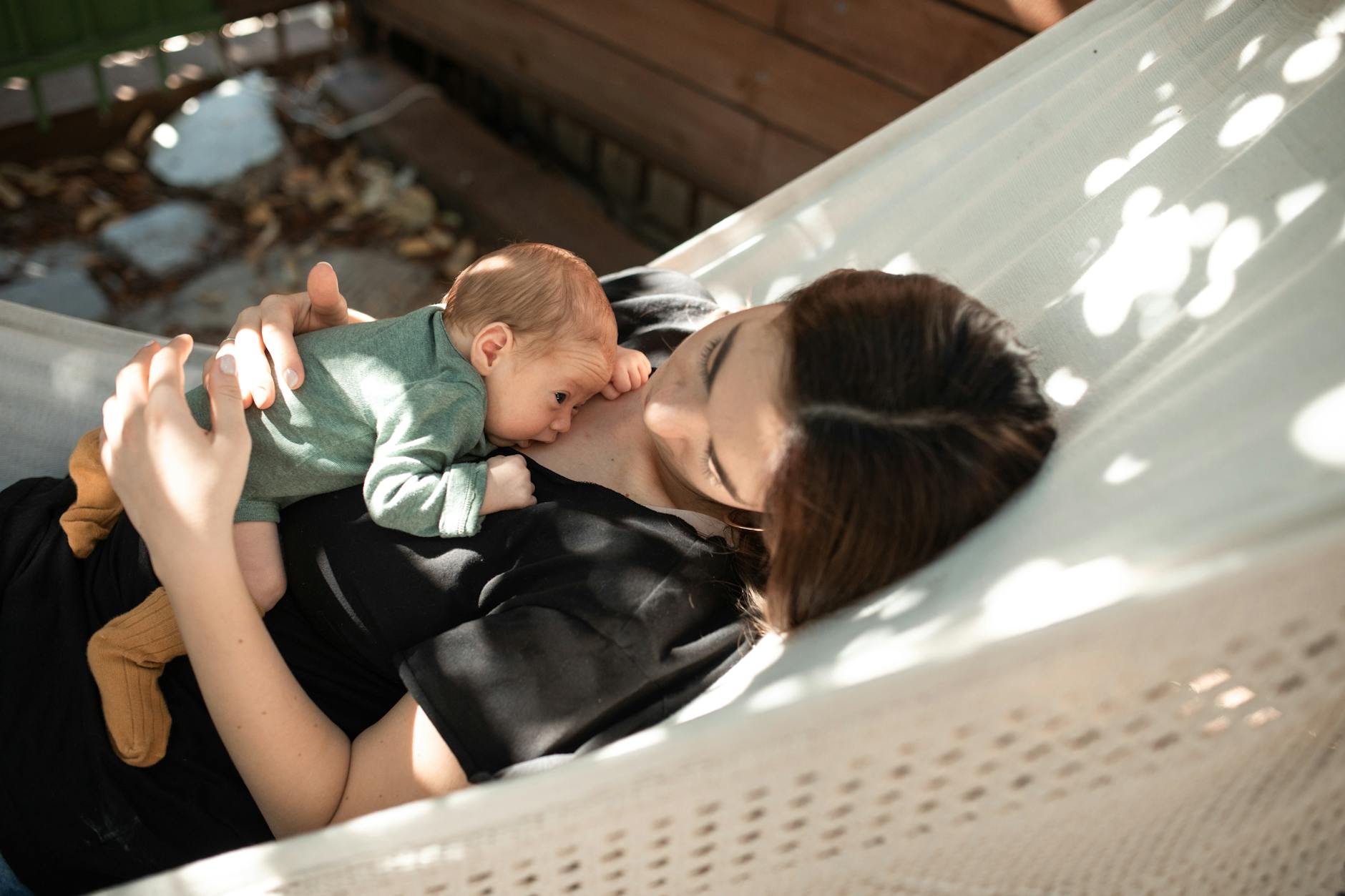 Parent with baby resting at Orlando theme park baby care center with nursing and changing facilities