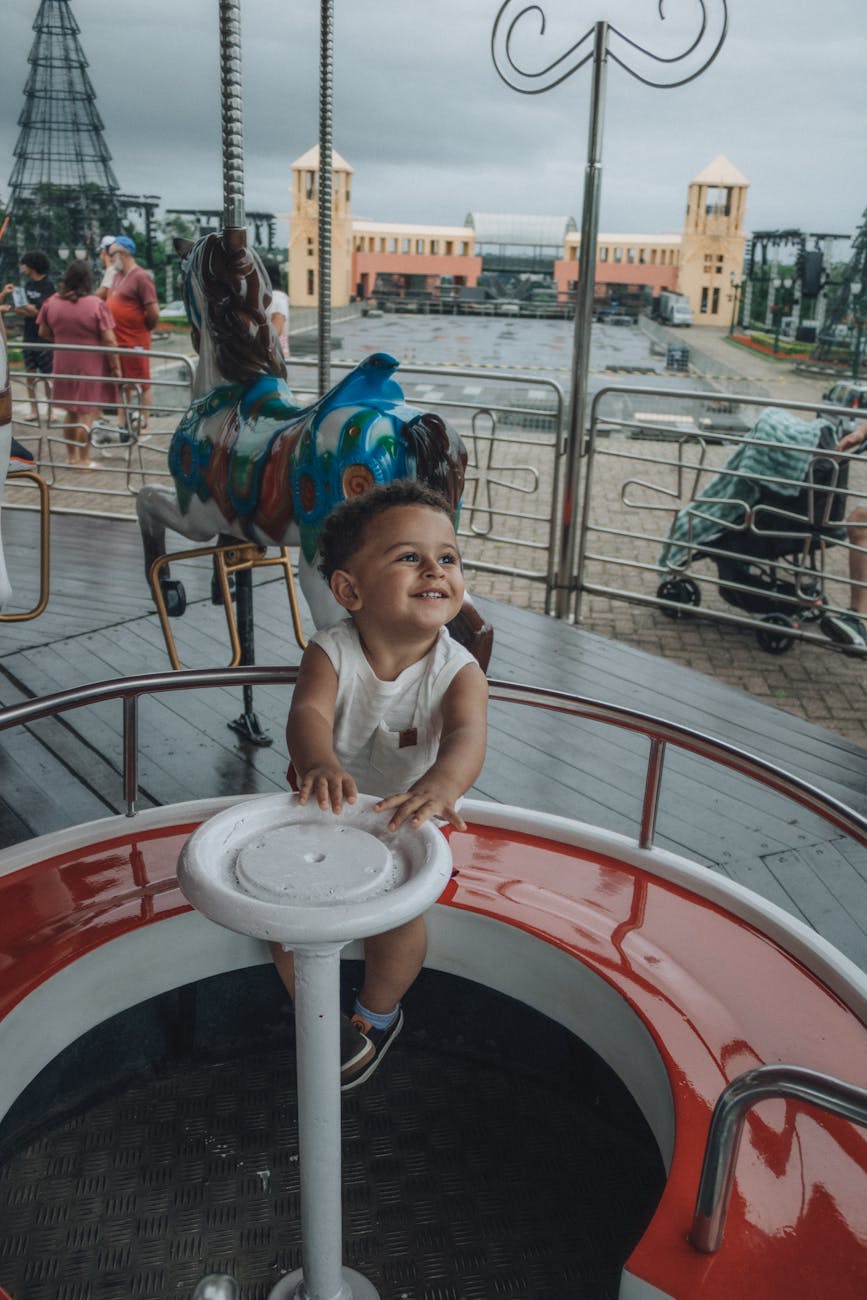 Toddler enjoying a gentle ride at an Orlando theme park designed for young children