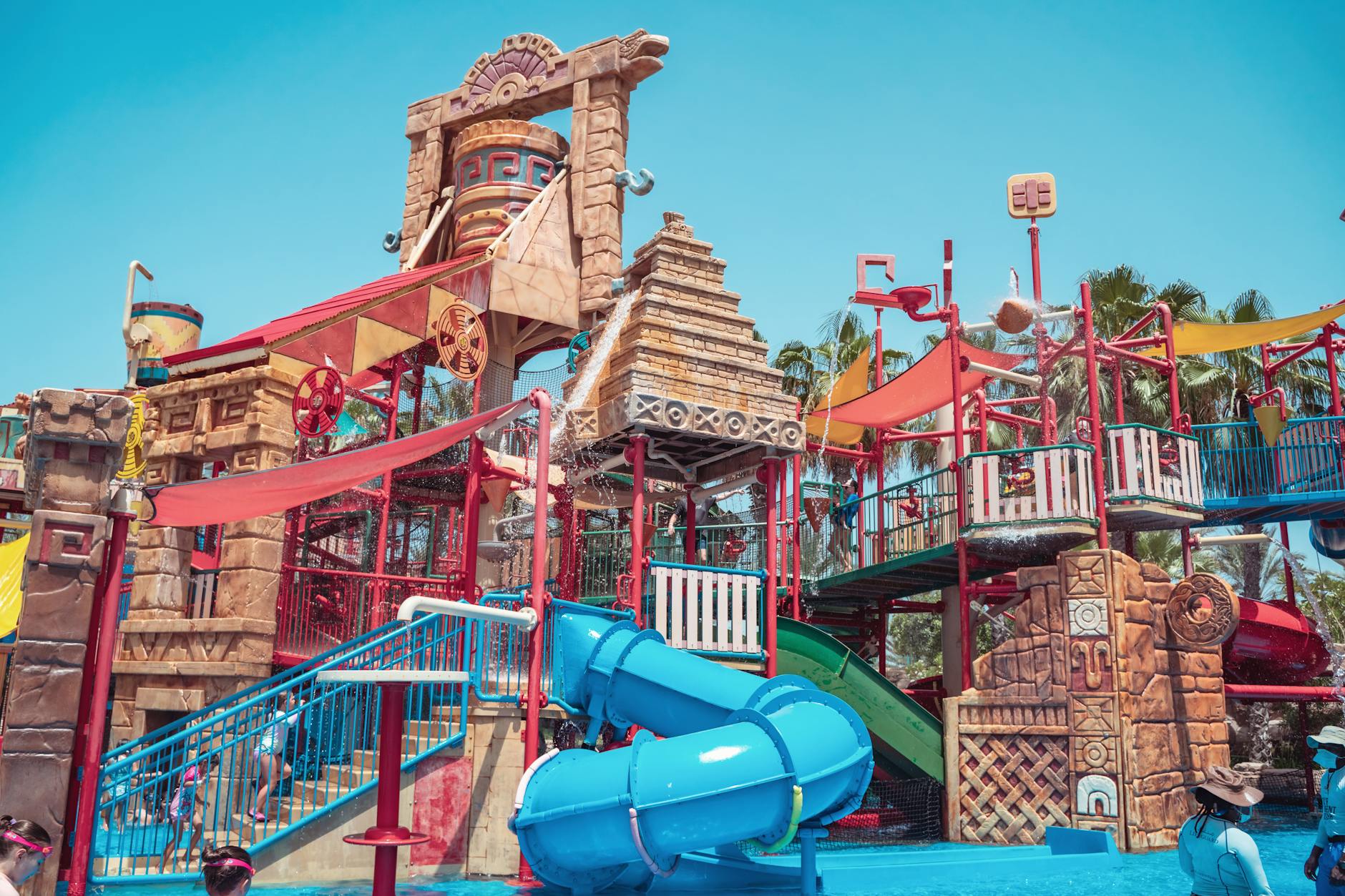Aquatica Orlando water slides surrounded by tropical palm trees and white sand beaches