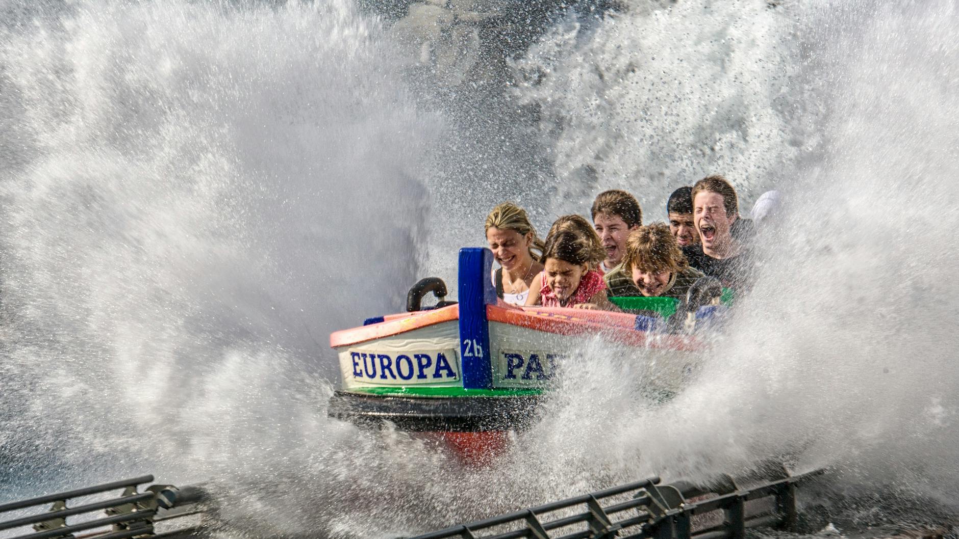 Family enjoying a gentle indoor boat ride at a theme park