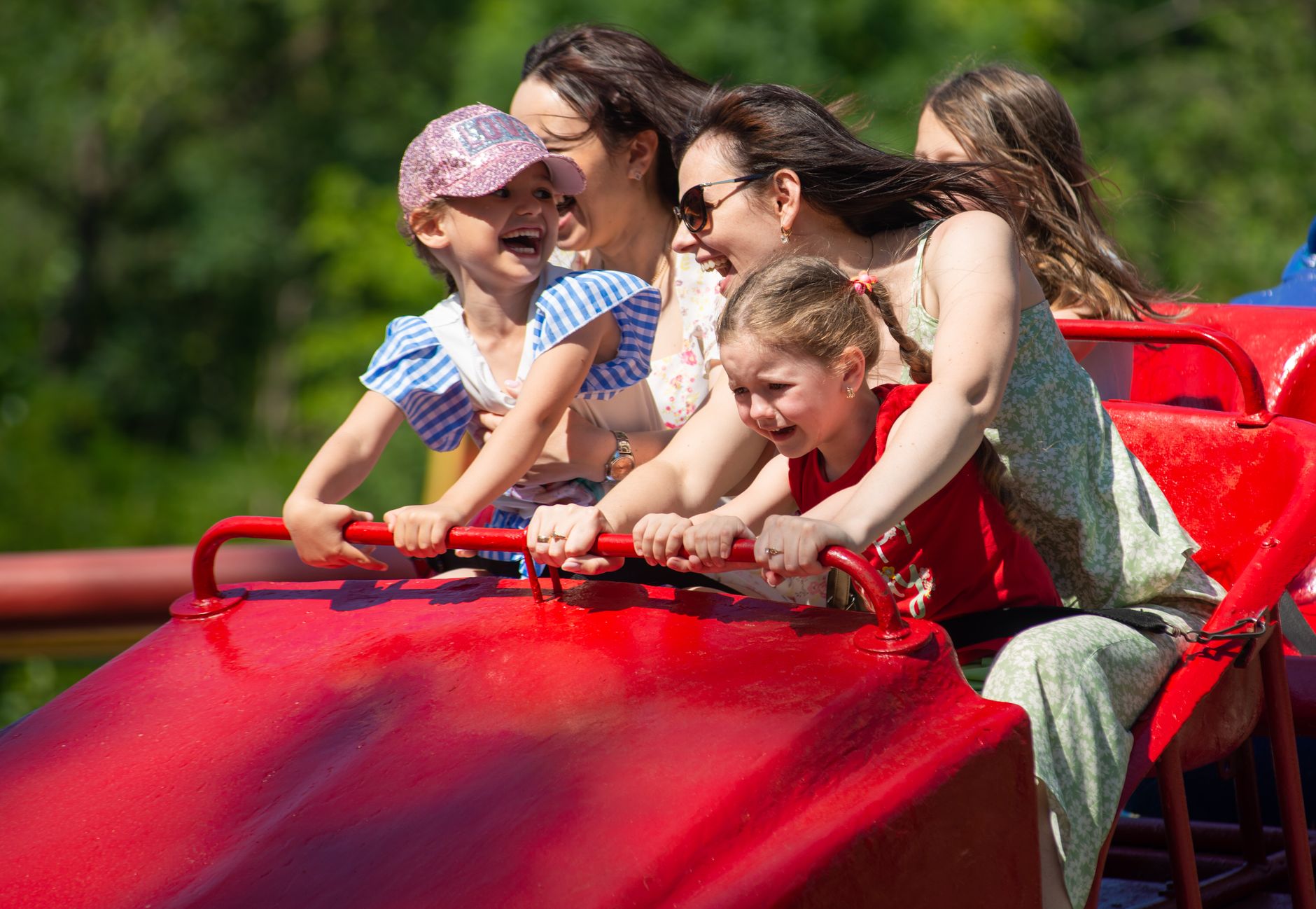 Children smiling on a family-friendly roller coaster
