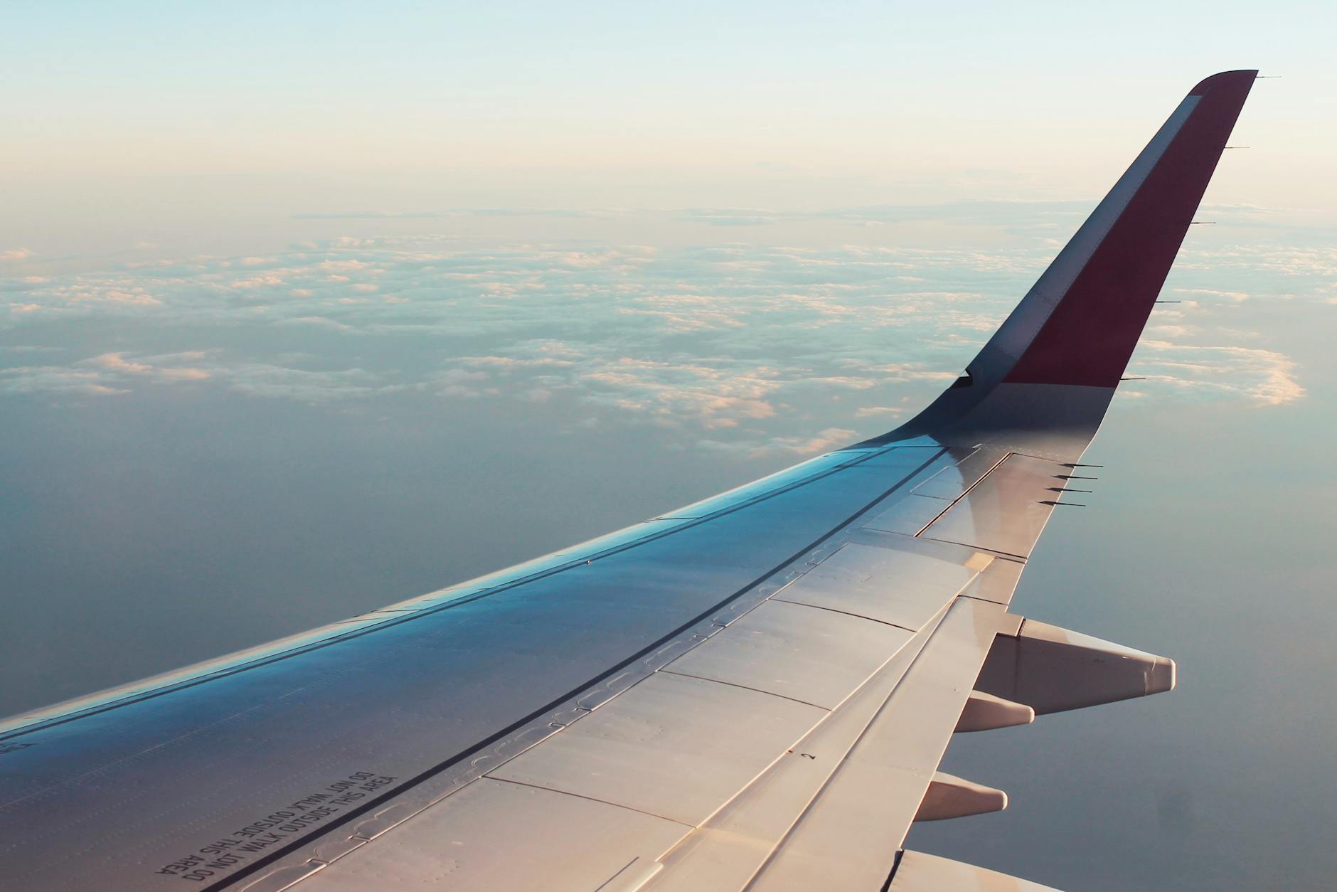 View of an airplane wing above clouds en route to Orlando on a cheap flight deal