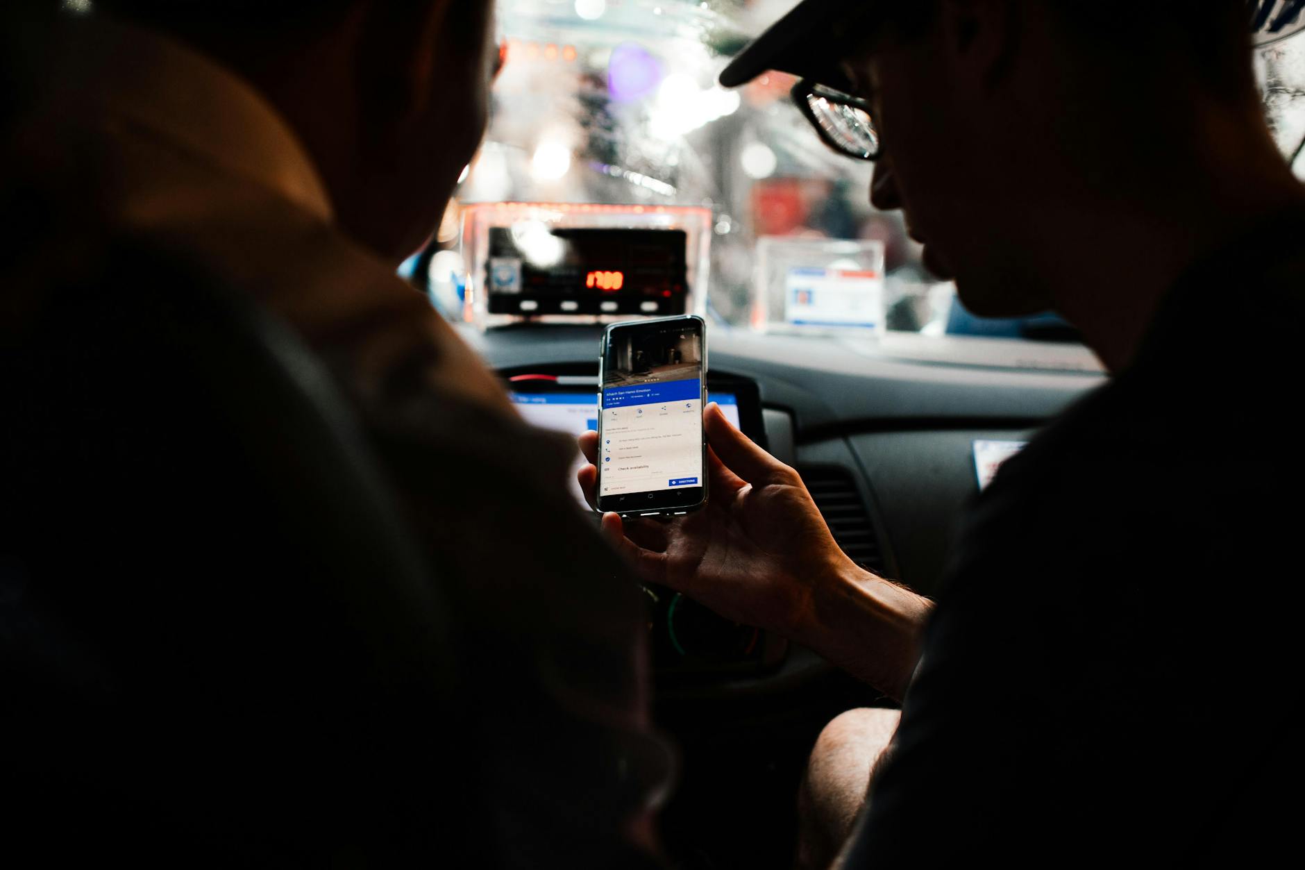 Traveler using a rideshare app to book a ride from Disney to Universal