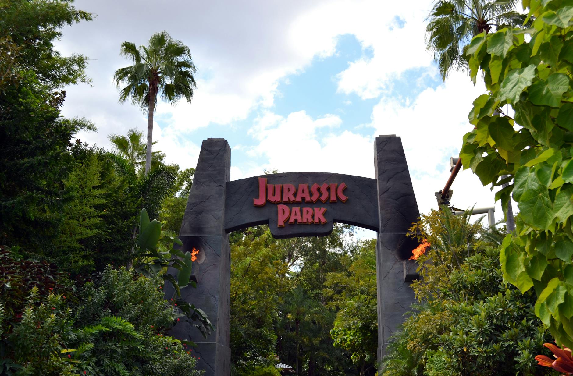 Entrance to an Orlando theme park with palm trees and parking structures