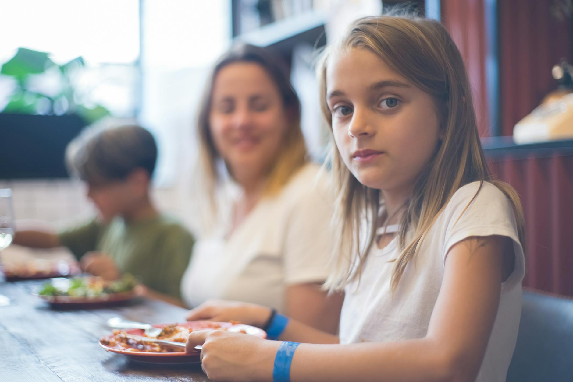 A family enjoying a character dining breakfast at a Walt Disney World restaurant