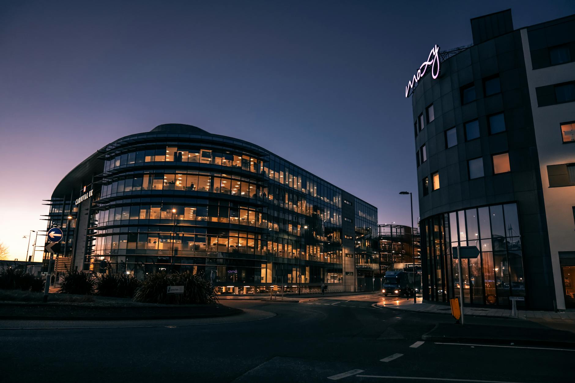 Modern hotel exterior glass facade evening lights