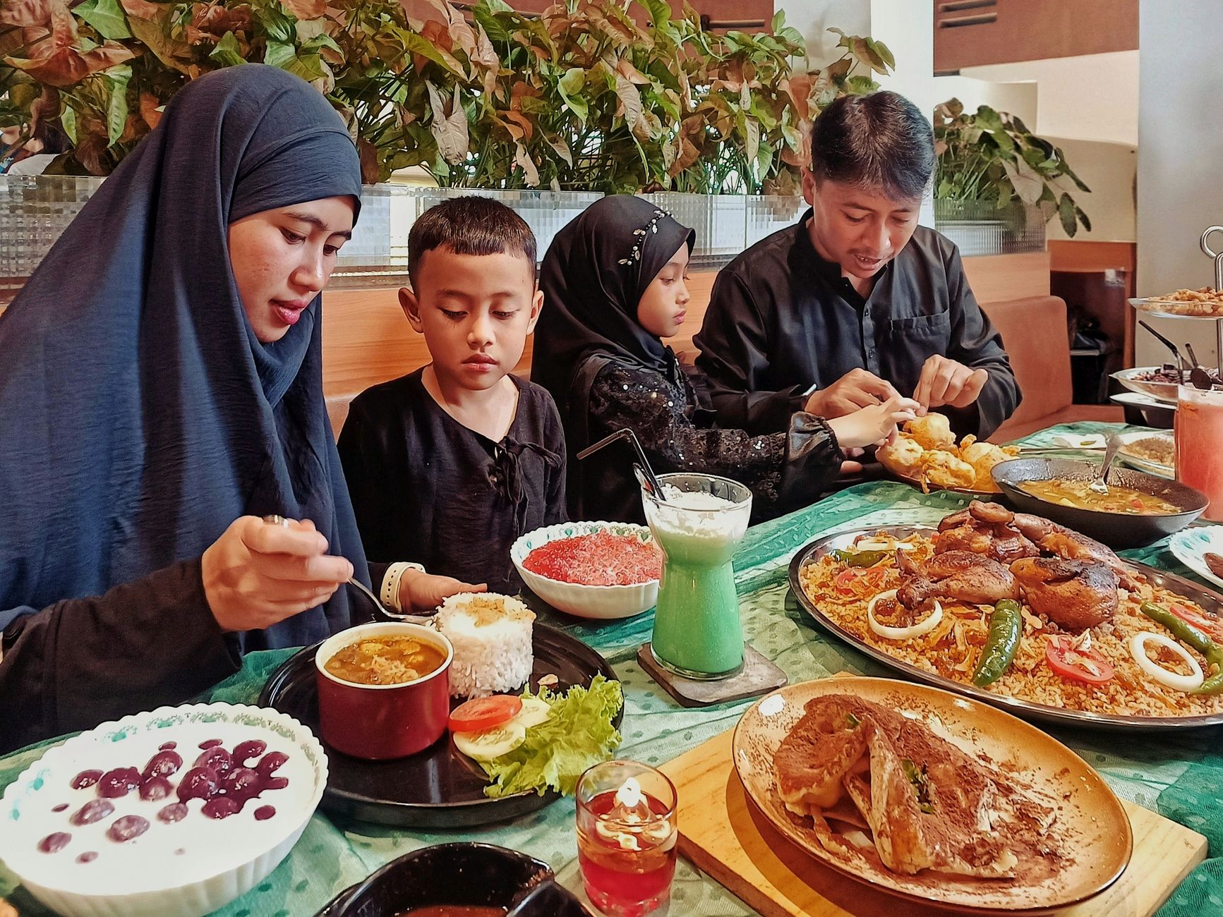 Family splitting a large shareable theme park entree to save money