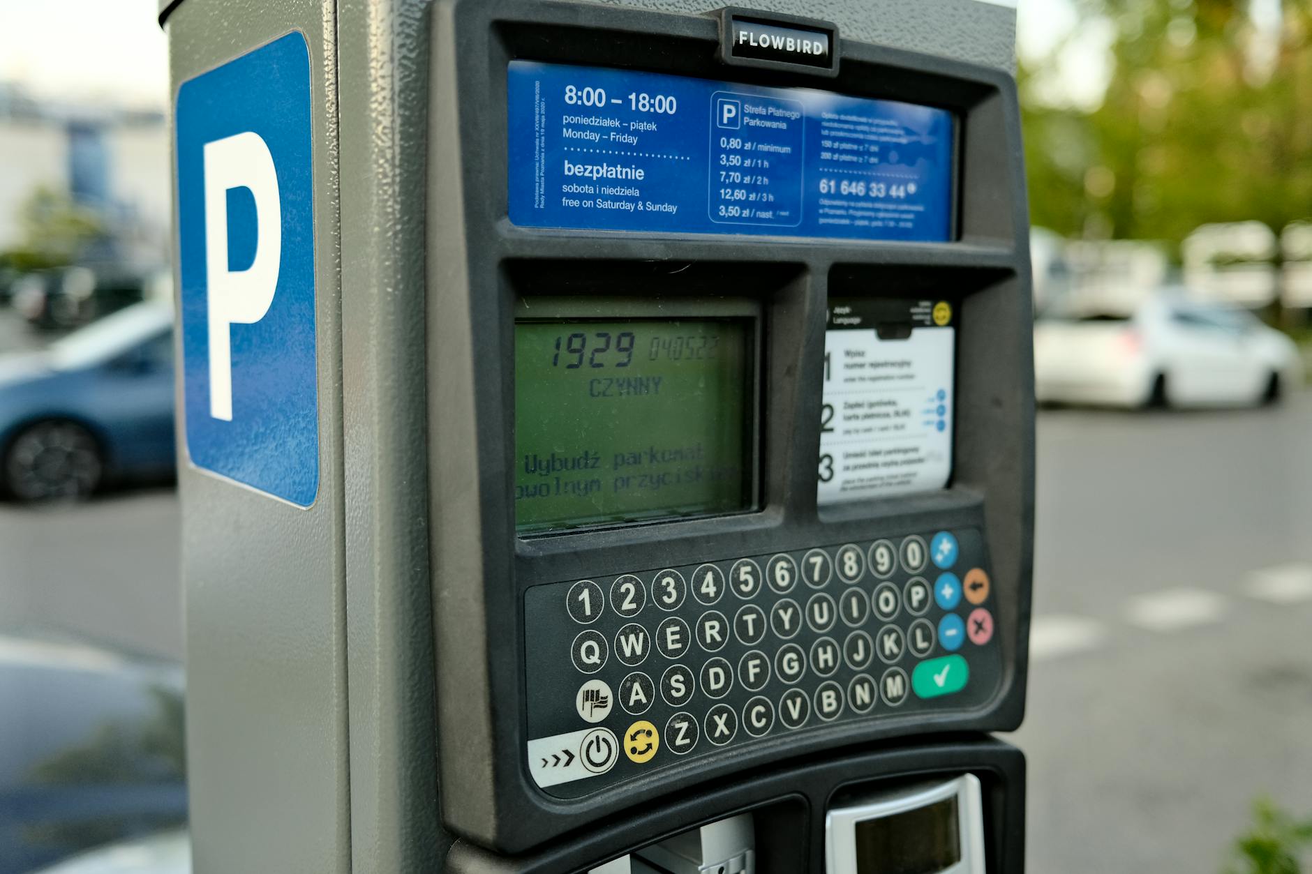 driver paying for theme park parking with a credit card at an entrance toll booth