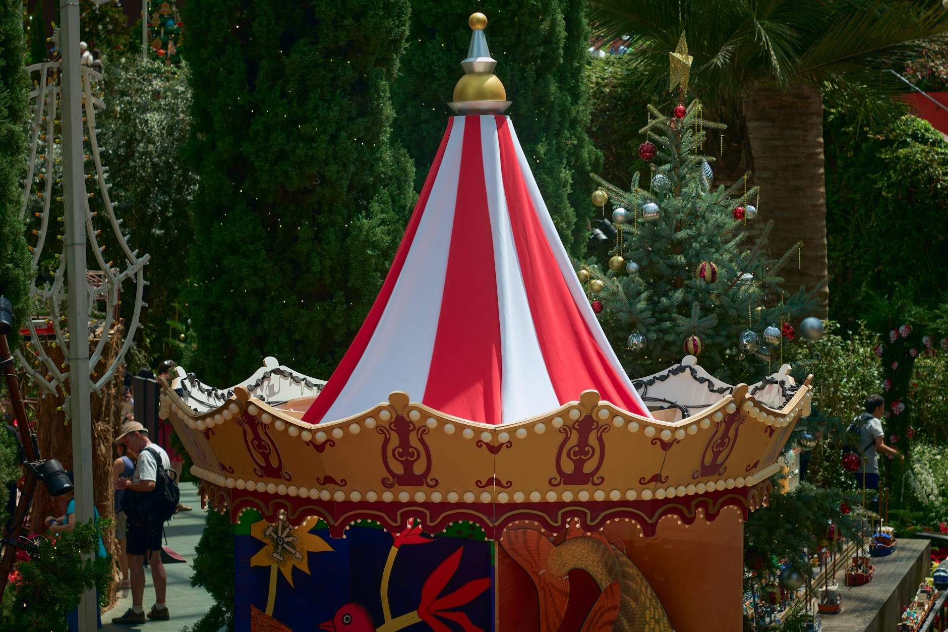 Festive holiday decorations and giant Christmas tree at an Orlando theme park entrance