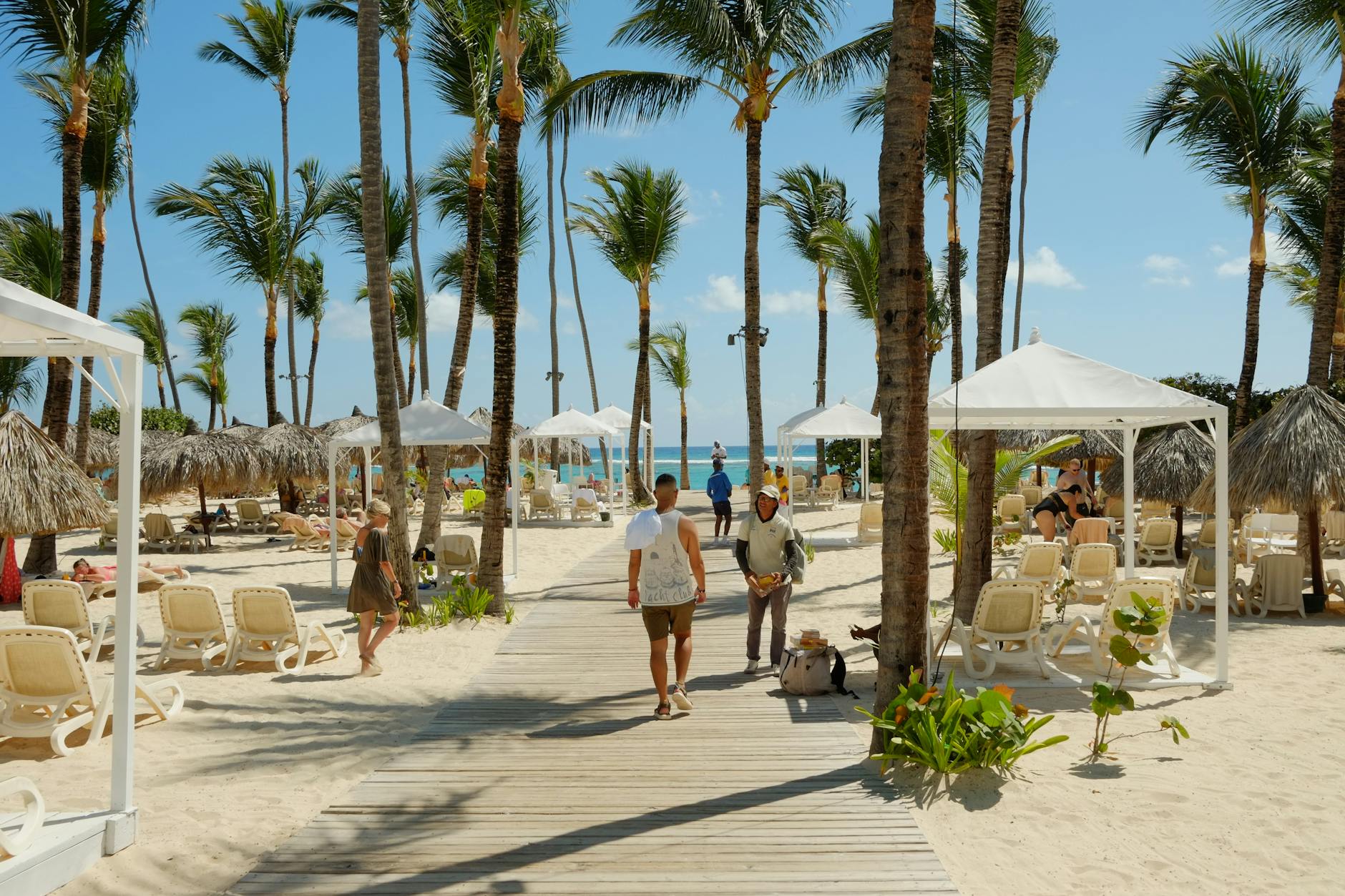 Rows of lounge chairs and shaded cabanas beside a wave pool at an Orlando water park
