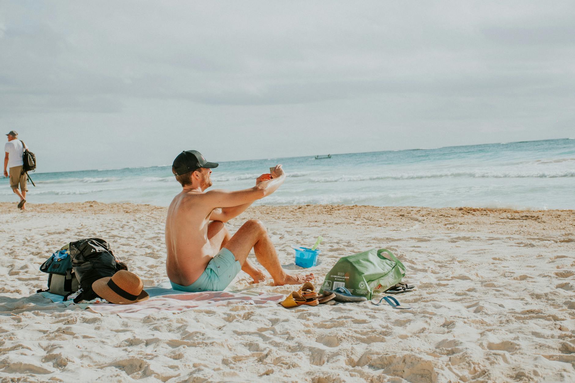 A packed water park day bag with towels, sunscreen, water shoes and a refillable bottle