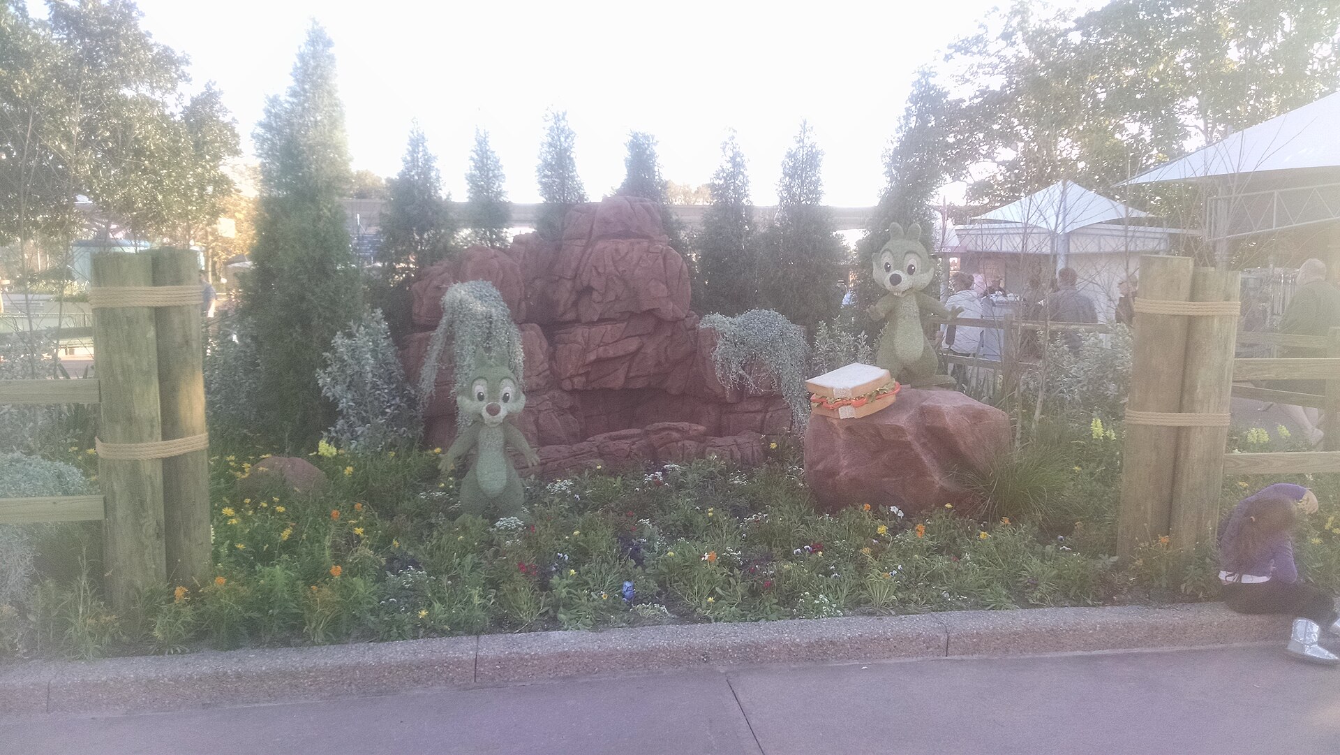 Chip and Dale topiaries arranged in a picnic scene with flower beds at EPCOT