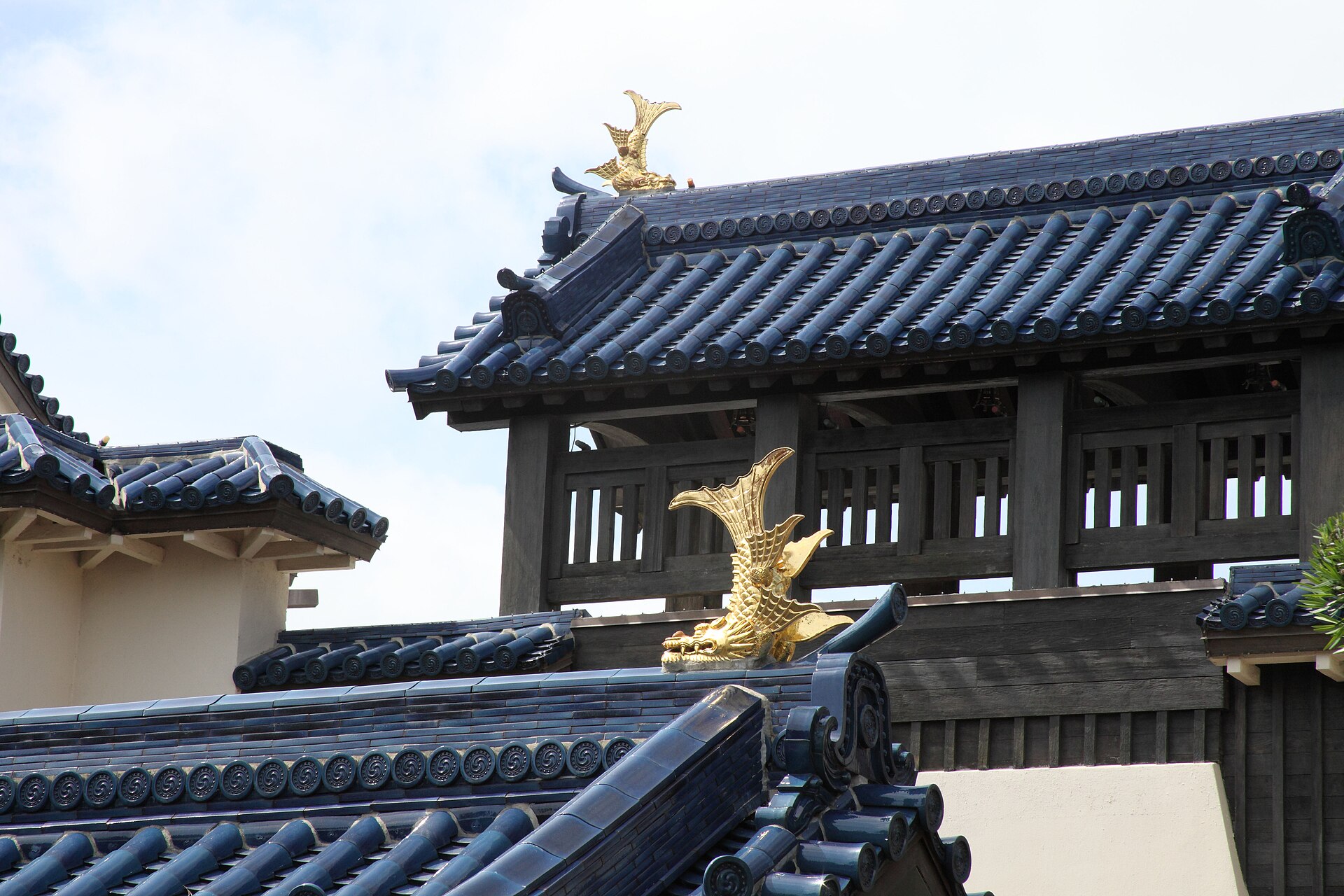 The blue tiled roof and golden shachihoko ornaments of the Japan pavilion castle at EPCOT