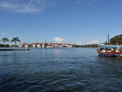 Disney's Grand Floridian Resort seen across Seven Seas Lagoon with a motor launch in the foreground