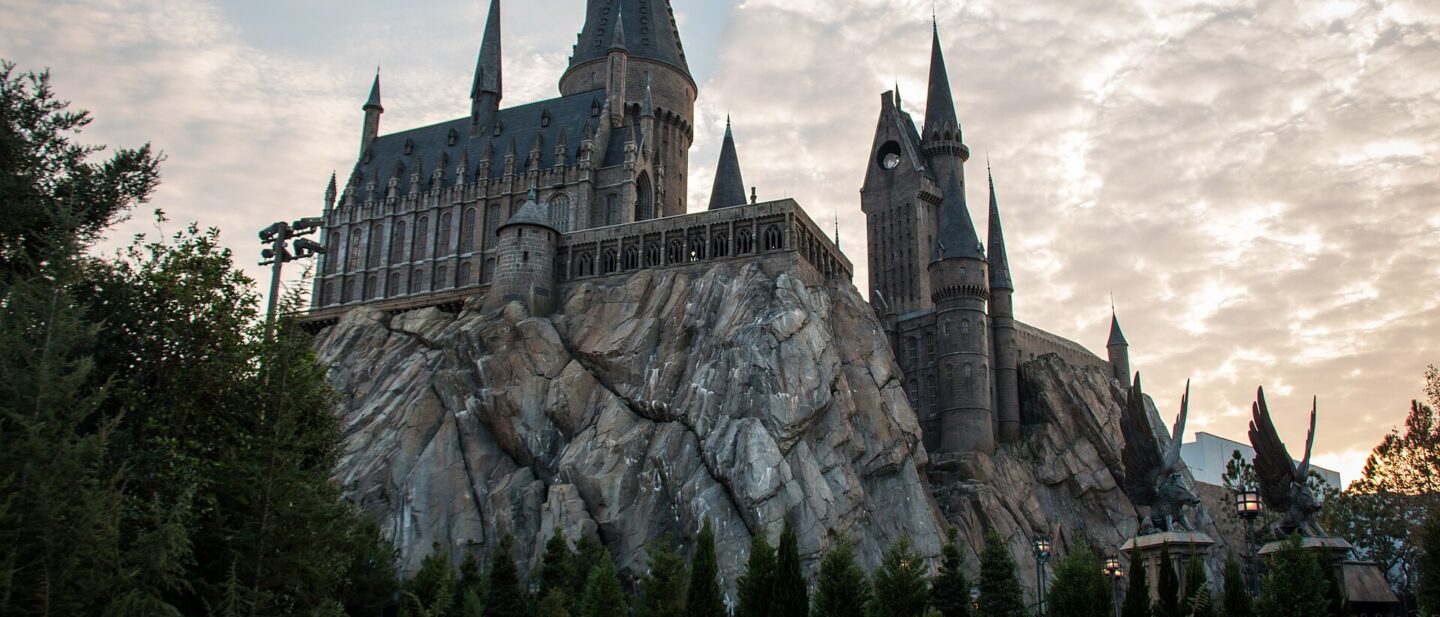 Hogwarts Castle rising above Hogsmeade at Islands of Adventure at dusk