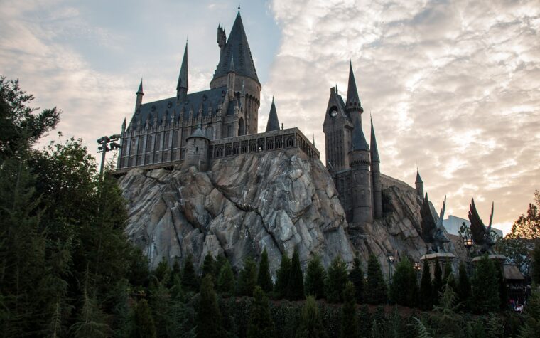 Hogwarts Castle rising above Hogsmeade at Islands of Adventure at dusk