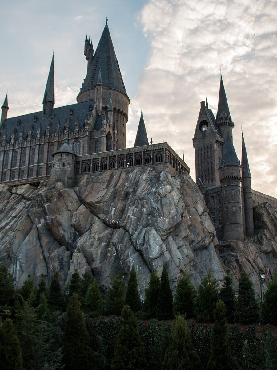 Hogwarts Castle rising above Hogsmeade at Islands of Adventure at dusk