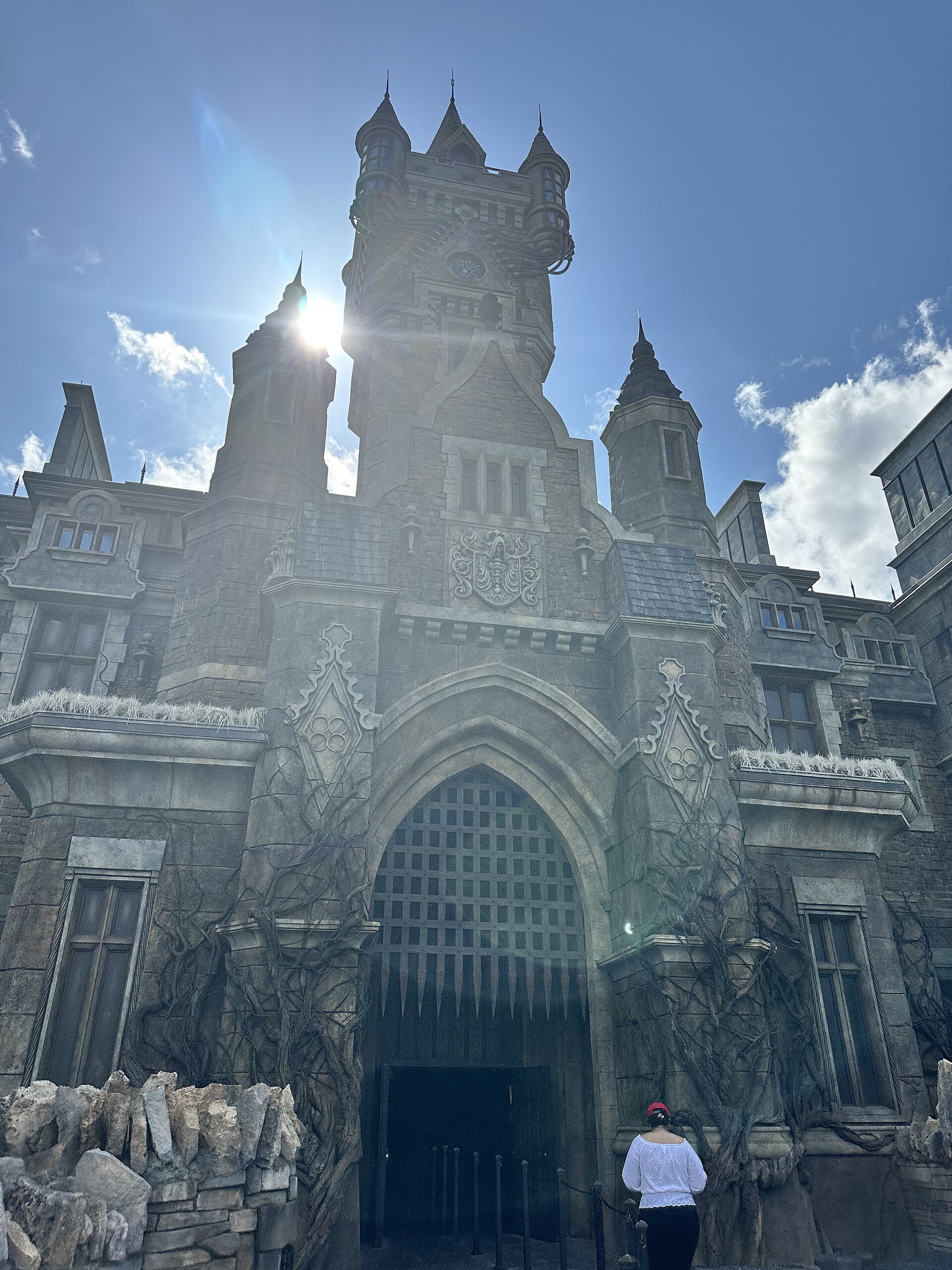 The stone gatehouse and towers of Frankenstein Manor, entrance to Monsters Unchained, under a bright sky