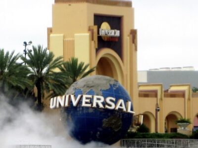 The Universal globe and entrance arch at Universal Studios Florida with fog drifting across the plaza