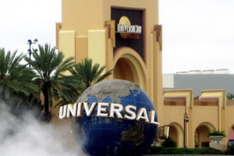 The Universal globe and entrance arch at Universal Studios Florida with fog drifting across the plaza