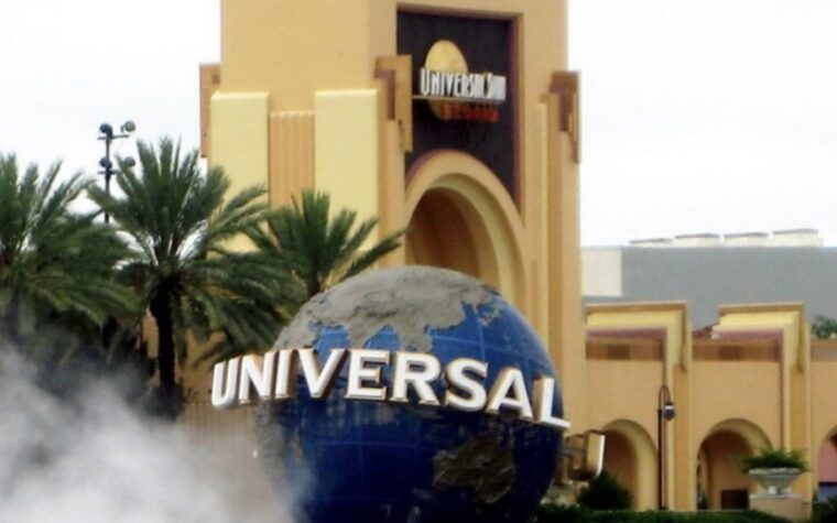 The Universal globe and entrance arch at Universal Studios Florida with fog drifting across the plaza