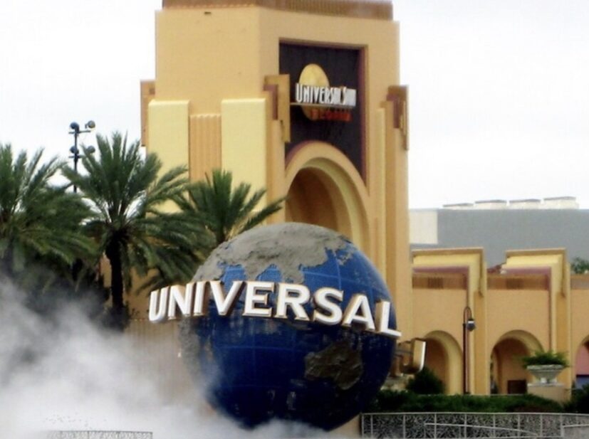 The Universal globe and entrance arch at Universal Studios Florida with fog drifting across the plaza