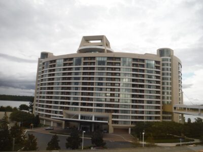 Bay Lake Tower, the curved Disney Vacation Club tower beside Disney's Contemporary Resort, with its skybridge on the right and Bay Lake behind