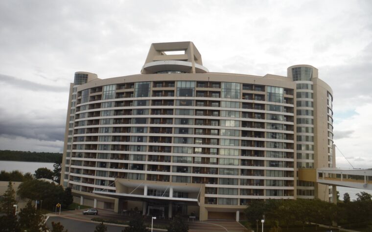 Bay Lake Tower, the curved Disney Vacation Club tower beside Disney's Contemporary Resort, with its skybridge on the right and Bay Lake behind
