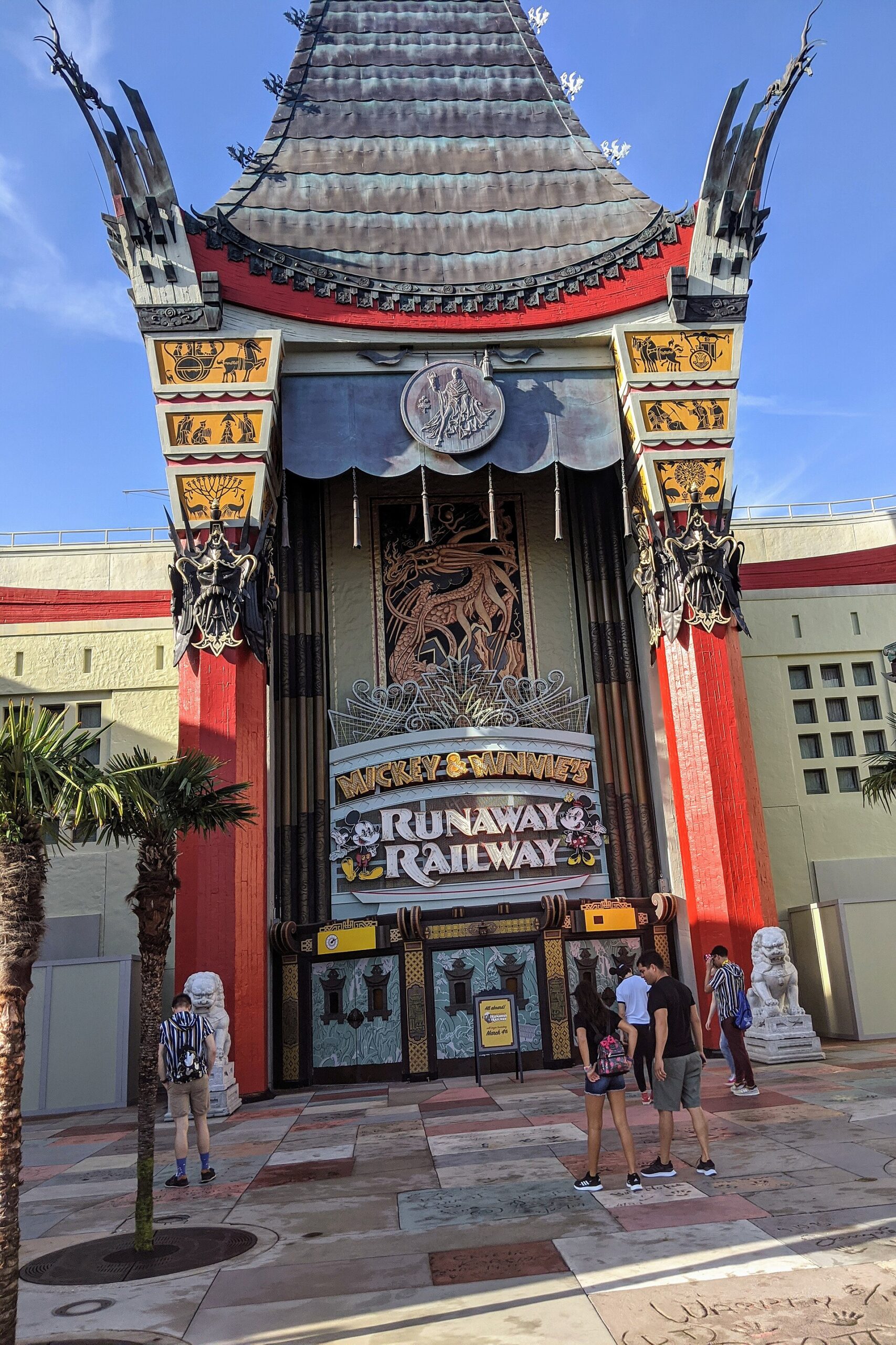The Chinese Theatre at Hollywood Studios with the Mickey and Minnie's Runaway Railway sign over its entrance and red columns either side